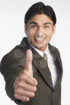 Businessman showing thumbs-up sign