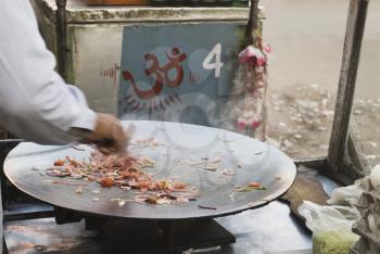 Man preparing food at a stall, New Delhi, India