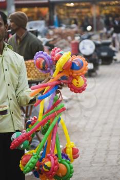 Vendor selling toys in a street market, New Delhi, India