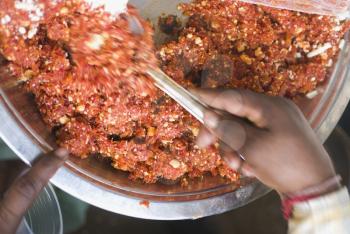 Man selling gajar halwa the traditional carrot puding in a street market, New Delhi, India