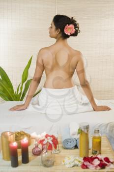 Young woman sitting on a massage table