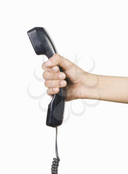 Person's hand holding a telephone receiver