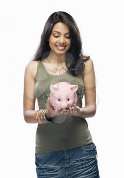 Young woman holding a piggy bank
