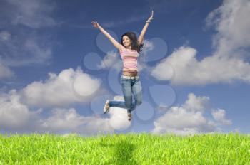 Young woman jumping in a field
