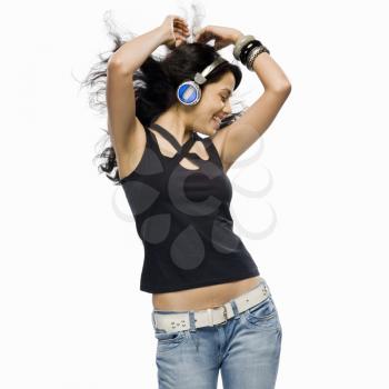 Young woman listening to music and dancing