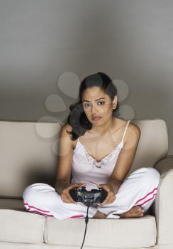 Portrait of a young woman playing video game