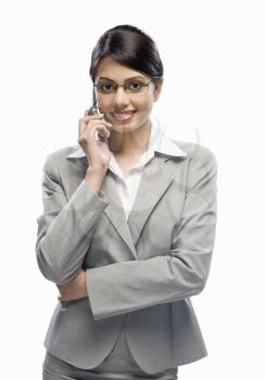 Businesswoman talking on a mobile phone against a white background