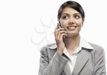 Businesswoman talking on a mobile phone against a white background