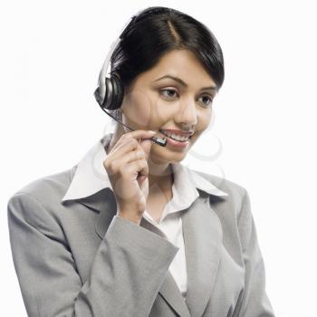 Female customer care executive wearing a headset against a white background