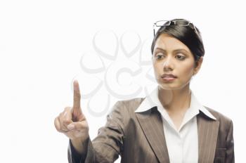 Businesswoman showing her index finger against a white background