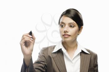 Businesswoman writing on a blank space against a white background
