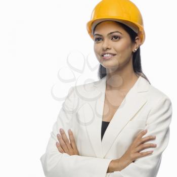 Female architect smiling with her arms crossed