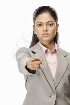 Portrait of a businesswoman pointing forward