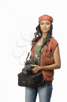 Portrait of a female photographer with digital camera