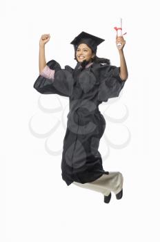 Portrait of a female graduate cheering with her diploma
