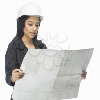 Female architect looking at a blueprint