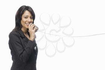 Businesswoman speaking in a tin can phone