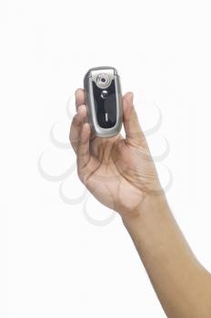 Person's hand showing a flip phone