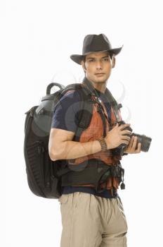 Portrait of a young male photographer holding a digital camera