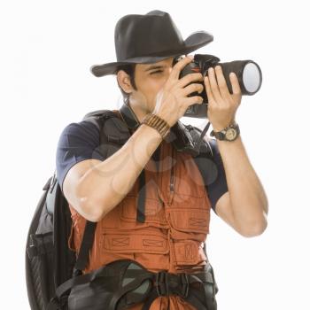 Young male photographer photographing with a digital camera