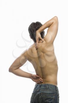 Rear view of a young man suffering from backache