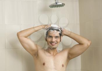 Close-up of a young man taking a shower