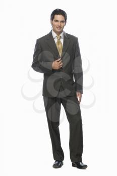 Portrait of a businessman standing against a white background