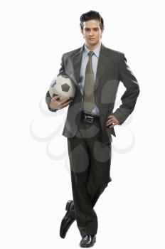 Portrait of a businessman holding a soccer ball