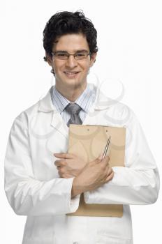 Portrait of a male doctor holding a clipboard