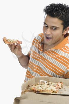 Close-up of a man looking at pizza