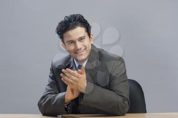 Portrait of a businessman clapping