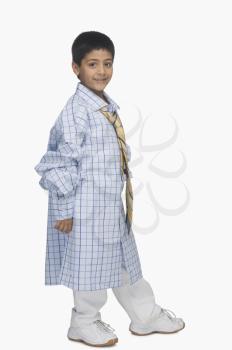 Portrait of a boy wearing oversized shirt and tie
