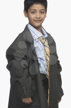 Portrait of a boy wearing oversized business clothing