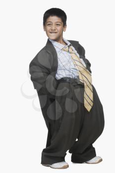 Boy wearing oversized suit and bending backward