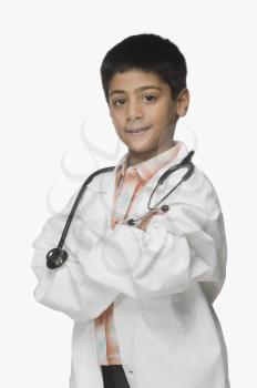 Portrait of a boy wearing lab coat and holding a stethoscope