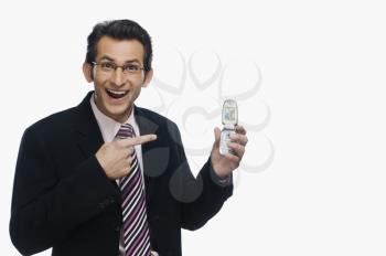 Businessman pointing at a mobile phone and smiling