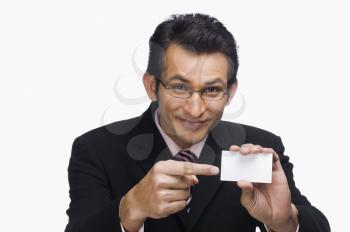 Portrait of a businessman showing a business card