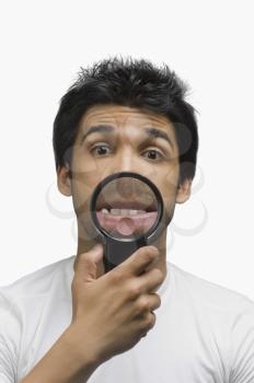 Man making a funny face in front of a magnifying glass