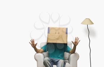 Man covering his face in a cardboard box