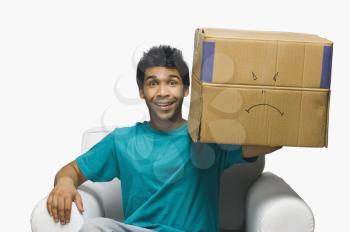 Man holding a cardboard box and smiling