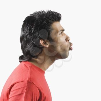 Side profile of a man puckering