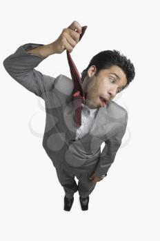 Businessman hanging himself with his tie