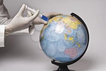 Close-up of a doctor's hand injecting a globe