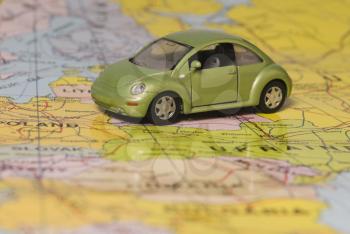 Close-up of a toy car on the world map