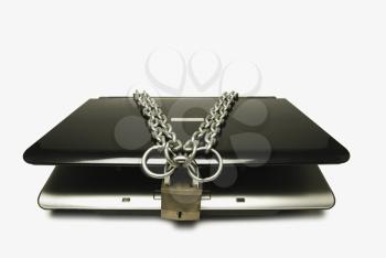 Close-up of a laptop tied with chain and a padlock
