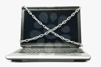 Close-up of a laptop tied with chains
