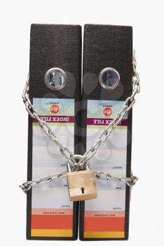 Two files tied up with chain and a padlock