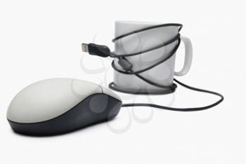 Close-up of a coffee cup and computer mouse
