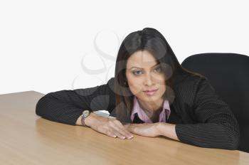 Portrait of a businesswoman leaning over a table