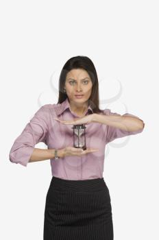 Businesswoman holding an hourglass